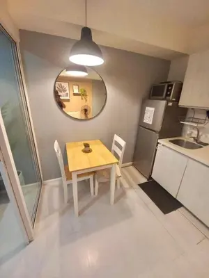 a small kitchen with a wooden table and a sink at SM Bicutan by Bahamas in Manila