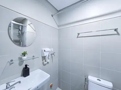 a white bathroom with a sink and a mirror at 1BR Condotel with Balcony at FAME Residences #FM33-1 in Manila