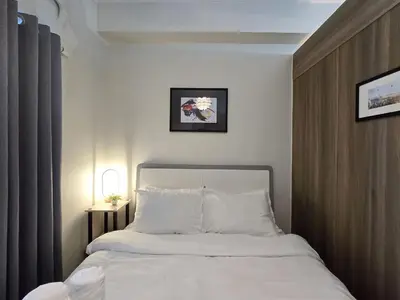 a bedroom with a bed with white sheets and pillows at 1BR Condotel with Balcony at FAME Residences #FM34-1 in Manila