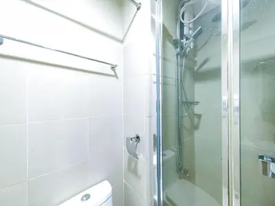 a bathroom with a shower with a glass door at 1BR Condotel with Balcony at FAME Residences #FM36-1 in Manila