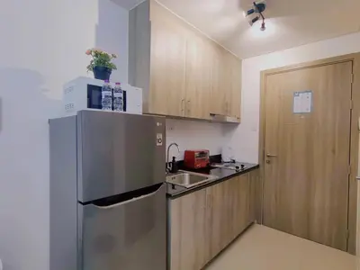 a kitchen with a stainless steel refrigerator and a sink at 1BR Condotel with Balcony at FAME Residences #FM36-1 in Manila