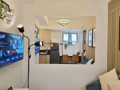 a living room with a view of a kitchen at 1BR Condotel with Balcony at FAME Residences #FM35-1 in Manila