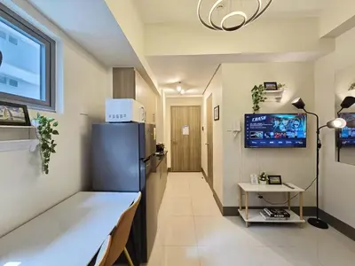 a hospital room with a refrigerator and a tv at 1BR Condotel with Balcony at FAME Residences #FM35-1 in Manila