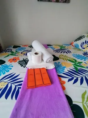 a bed with a towel and a roll of toilet paper on it at Comfystay at Sea Residences in Manila
