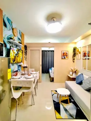 a living room with a table and a couch at Comfystay at Sea Residences in Manila