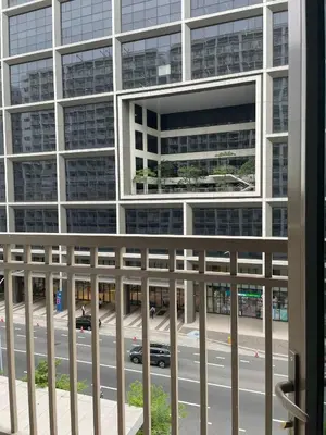 a view of a building from a balcony at Walking Distance to Mall of Asia - Spacious Condo with Hot Shower and Balcony in Manila