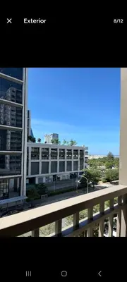 a view of a building from a balcony at Walking Distance to Mall of Asia - Spacious Condo with Hot Shower and Balcony in Manila