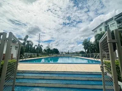 a swimming pool with stairs leading to a house at MAINE'S STAYCATION at Enchanted Kingdom in Santa Rosa