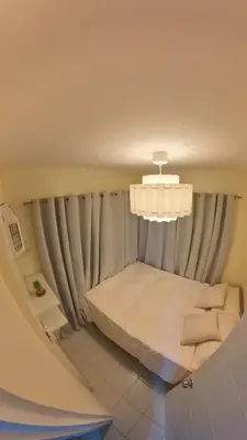 a small room with a bed and a chandelier at MAINE'S STAYCATION at Enchanted Kingdom in Santa Rosa