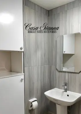 a bathroom with a sink and a mirror at Casa Gianna at Berkeley Suites, South Forbes in Silang
