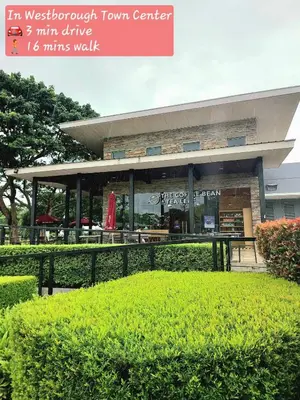 a building with a table and chairs in front of it at Casa Gianna at Berkeley Suites, South Forbes in Silang
