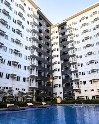 two large apartment buildings next to a swimming pool at Blooming Friends Retreat in Manila