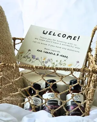 a basket of wine bottles with a welcome sign at Blooming Friends Retreat in Manila