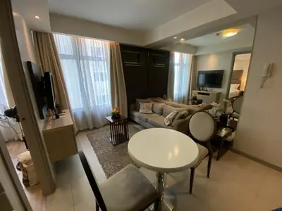 a living room with a couch and a table at Makati 1BR High Floor in Manila