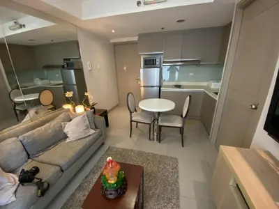 a living room with a couch and a table at Makati 1BR High Floor in Manila
