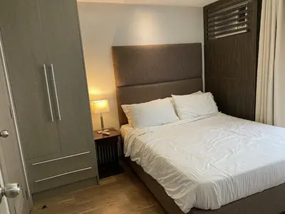 a bedroom with a large bed with white sheets at Makati 1BR High Floor in Manila