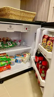an open refrigerator filled with lots of food at The Cozy Fabb in Manila
