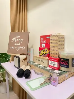 a table with books and a sign on top of it at The Cozy Fabb in Manila