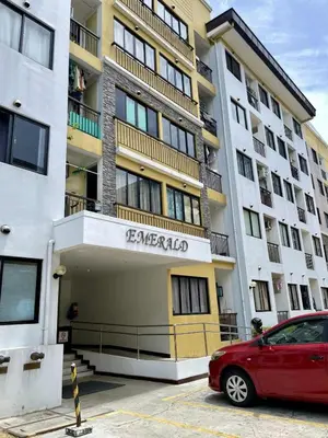 a red car parked in front of a building at Warm Modern Condo Apartment with Pool & Balcony - East Residences Ortigas Pasig City in Manila