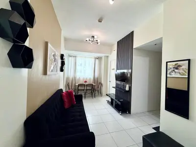 a living room with a couch and a table at Spacious 2br condo at Quezon City Mezza Residences 1 in Manila