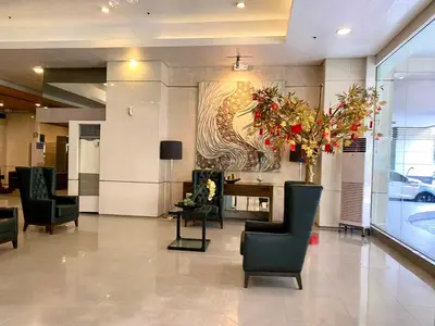 a lobby with chairs and a table and a painting at Spacious 2br condo at Quezon City Mezza Residences 1 in Manila