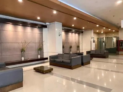 a lobby with couches and tables in a building at Spacious 2br condo at Quezon City Mezza Residences 1 in Manila