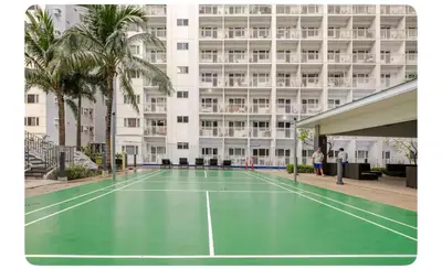 a tennis court in front of a building at Porongs Oasis in Manila