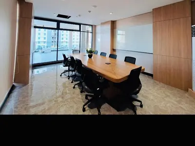 a large conference room with a wooden table and chairs at Cozy Vibes Retreat in Makati in Manila