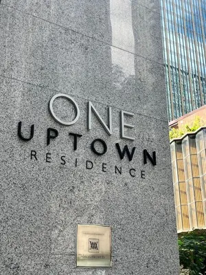 a sign on the side of a building at Cozy 1br unit in Uptown BGC in Manila