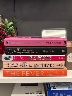 a stack of books sitting on a shelf at The Lay-by Fame MRT Megamall Greenfield Greenhills in Manila