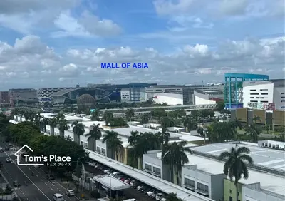 a view of a city with a sign that reads mall of asia at Tom's Place in Manila