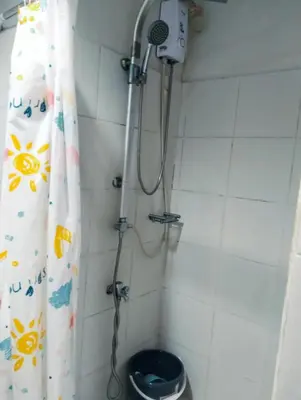 a shower in a bathroom with a shower curtain at Jovy Place At Shore Residences&Sea Residences near Moa in Manila
