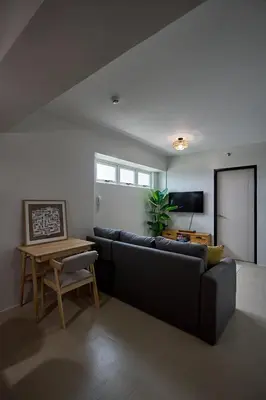 a living room with a couch and a table at I-LAND Residences Sucat near NAIA w Wifi free parking in Manila