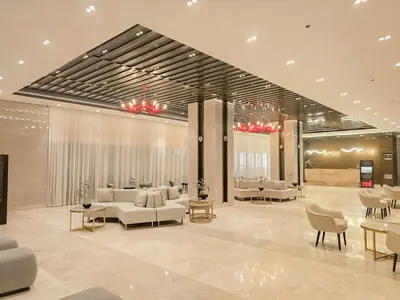 a lobby with couches and tables in a building at Cozy Twin Suite with Balcony in Makati Free WiFi in Manila