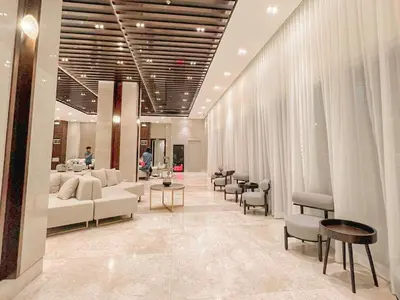 a large room with couches and tables and chairs at Cozy Twin Suite with Balcony in Makati Free WiFi in Manila