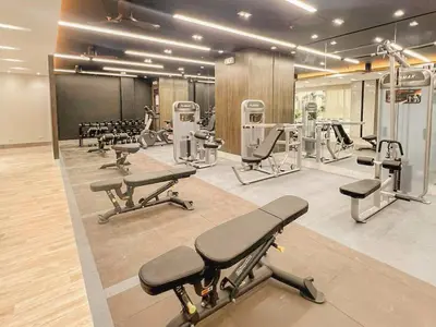 a gym with several exercise equipment in a room at Cozy Twin Suite with Balcony in Makati Free WiFi in Manila