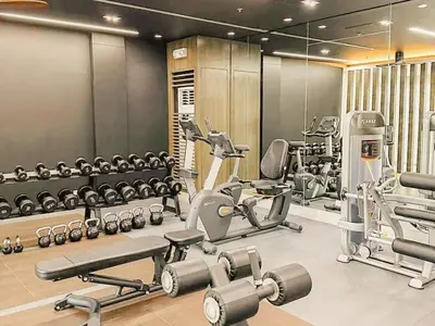 a gym with several treadmills and machines at Cozy Twin Suite with Balcony in Makati Free WiFi in Manila