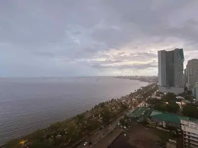 an aerial view of a city and the ocean at Ocean view malate manila in Manila