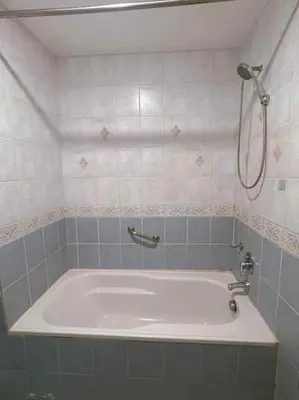 a bath tub in a bathroom with a shower at Ocean view malate manila in Manila