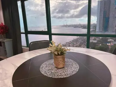 a table with a potted plant sitting on top of it at Ocean view malate manila in Manila
