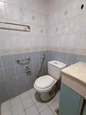 a bathroom with a toilet and a sink at Ocean view malate manila in Manila