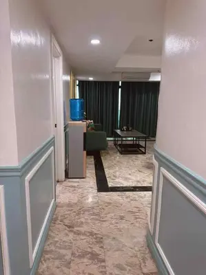 a hallway of a hotel with a living room at Ocean view malate manila in Manila