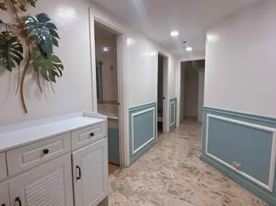 a large bathroom with a sink and a mirror at Ocean view malate manila in Manila
