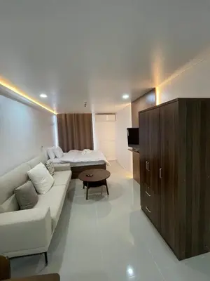 a living room with a couch and a bed at Makati City Antel Spa Residences 9B in Manila