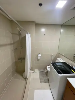 a bathroom with a shower and a toilet at Makati City Antel Spa Residences 9B in Manila