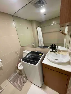 a small bathroom with a toilet and a sink at Makati City Antel Spa Residences 9B in Manila