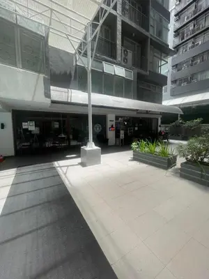 a building with a pole in the middle of a courtyard at Makati City Antel Spa Residences 9B in Manila