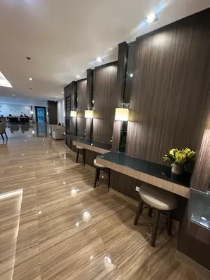a hotel lobby with a row of tables and chairs at air residences in Manila