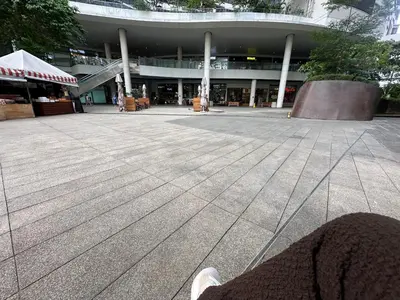 a person sitting in front of a building at air residences in Manila