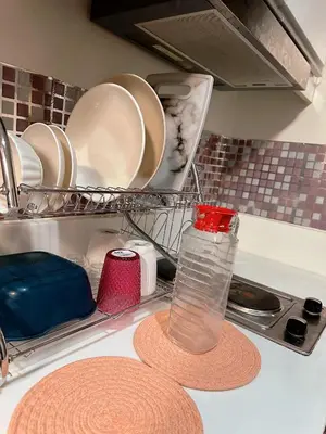 a kitchen counter top with plates and a bottle of water at air residences in Manila